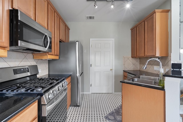 kitchen with sink, backsplash, and stainless steel appliances