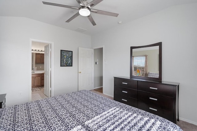 carpeted bedroom with baseboards, ensuite bathroom, and a ceiling fan