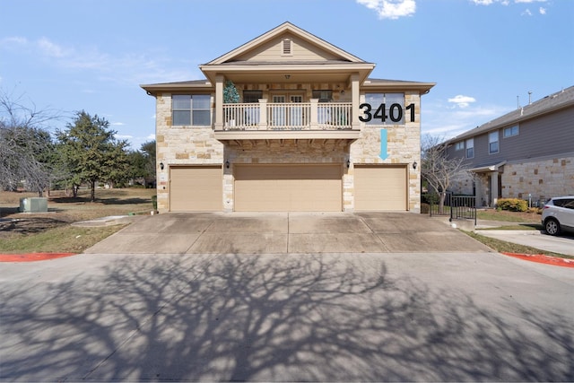 view of front of property featuring a garage and a balcony