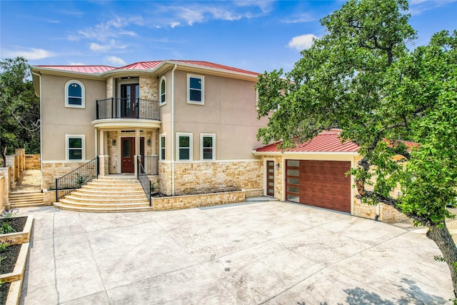 view of front of house featuring a balcony and a garage