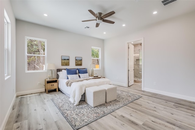 bedroom with ceiling fan, connected bathroom, and light hardwood / wood-style flooring