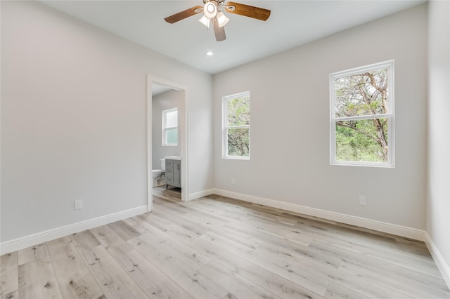 spare room featuring light hardwood / wood-style floors and ceiling fan