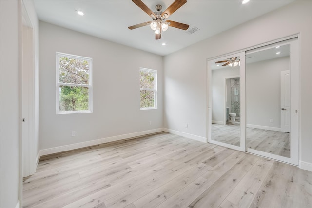 unfurnished bedroom featuring ceiling fan, light hardwood / wood-style flooring, and a closet