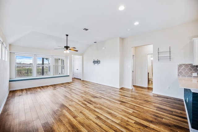 unfurnished living room featuring lofted ceiling, ceiling fan, and hardwood / wood-style flooring