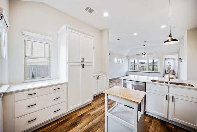 kitchen featuring pendant lighting, dishwasher, white cabinetry, sink, and ceiling fan