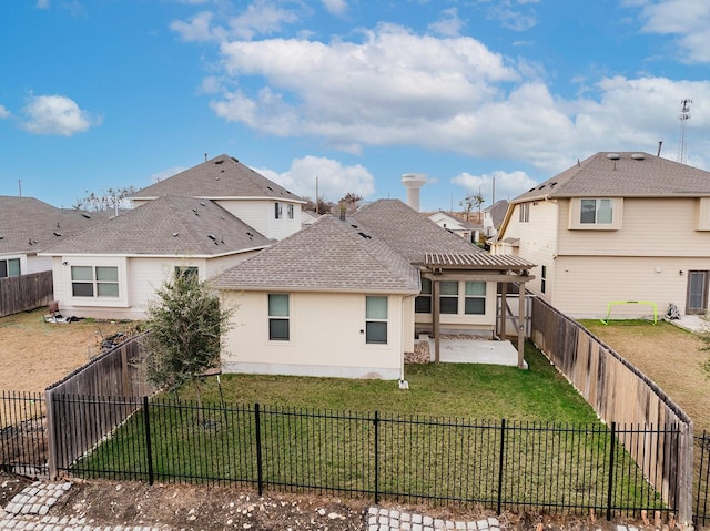 rear view of house with a lawn and a patio