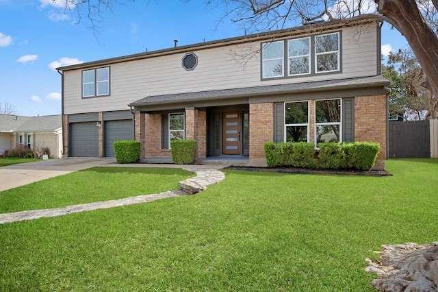 view of property featuring a front yard and a garage