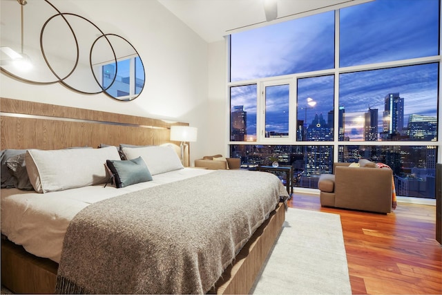 bedroom featuring floor to ceiling windows and hardwood / wood-style floors