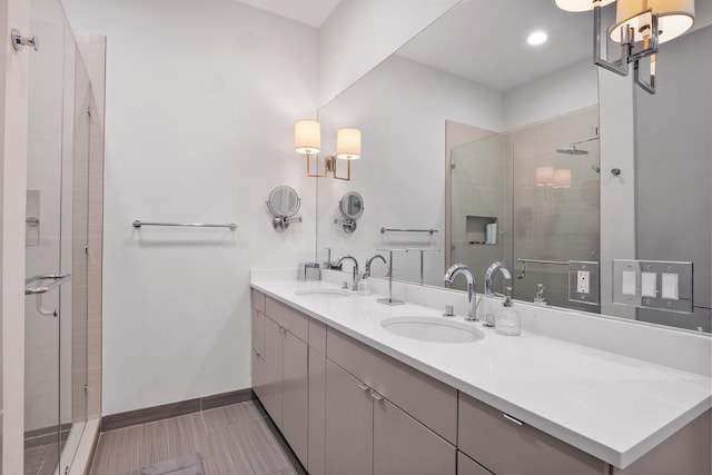 bathroom with walk in shower, vanity, and tile patterned floors