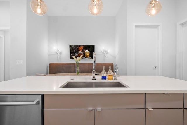 kitchen with dishwasher, sink, gray cabinetry, and pendant lighting