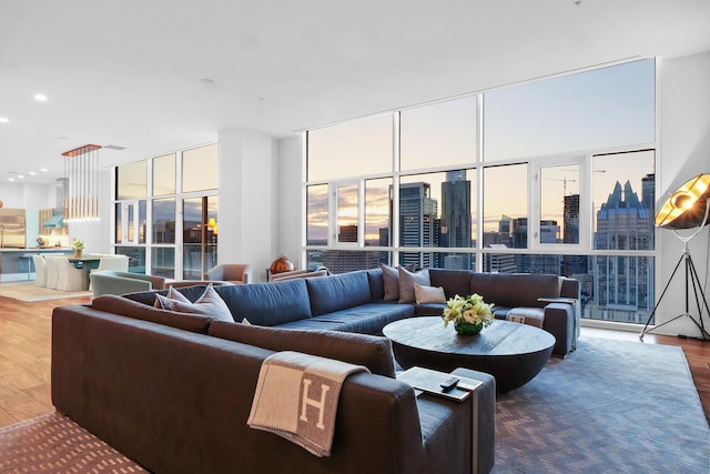 living room featuring expansive windows and hardwood / wood-style floors