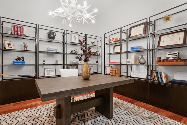 office with an inviting chandelier and wood-type flooring