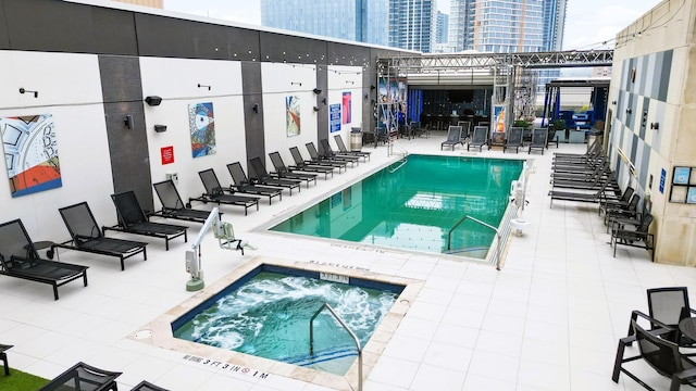 view of swimming pool featuring a community hot tub