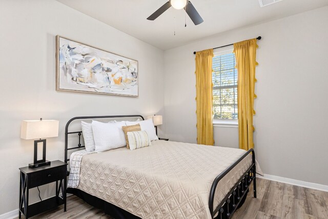 bedroom featuring hardwood / wood-style flooring and ceiling fan