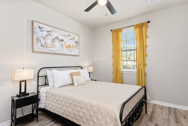 376 Spider Lily Dr, Kyle, TX 78640 - bedroom with wood finished floors, baseboards, and a ceiling fan