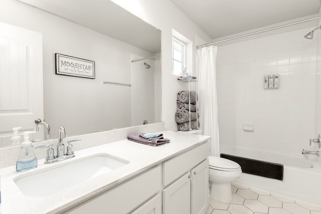 full bathroom with vanity, toilet, tile patterned flooring, and shower / bath combo with shower curtain