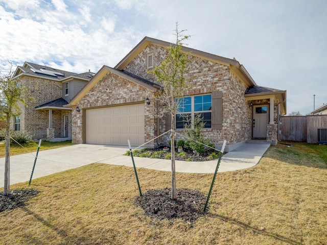 view of front facade featuring a front lawn, concrete driveway, and brick siding