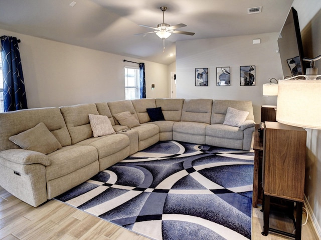 living room with lofted ceiling, light wood-type flooring, and ceiling fan