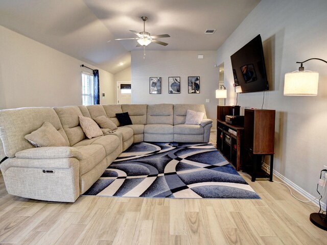 living room with ceiling fan and vaulted ceiling