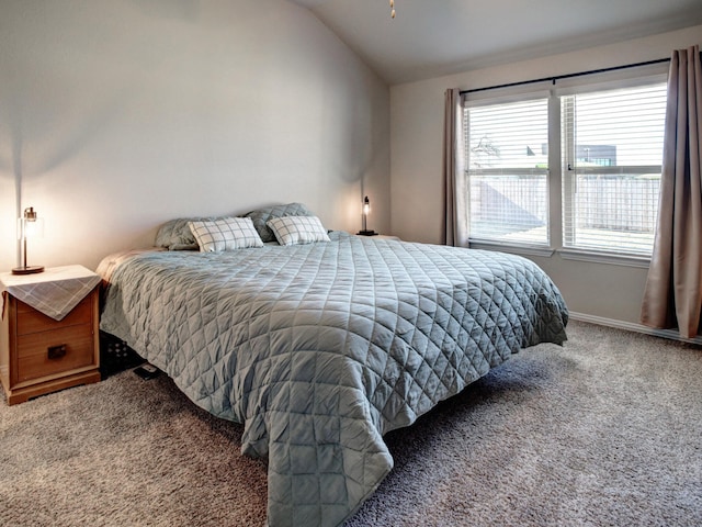 carpeted bedroom featuring lofted ceiling