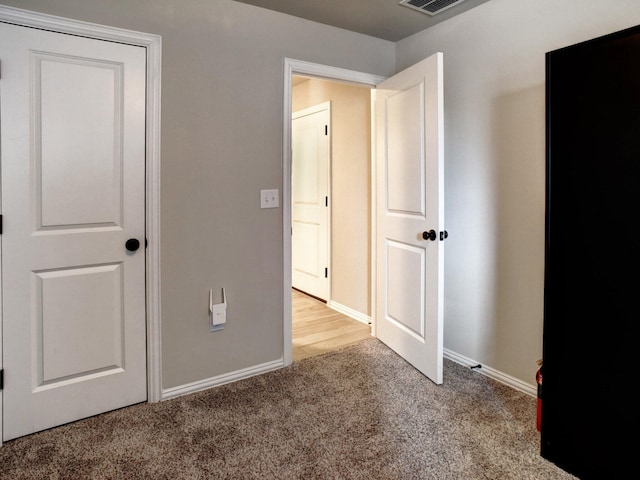 unfurnished bedroom featuring light carpet