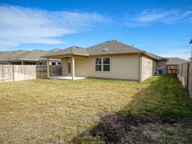 back of house featuring a patio area and a yard