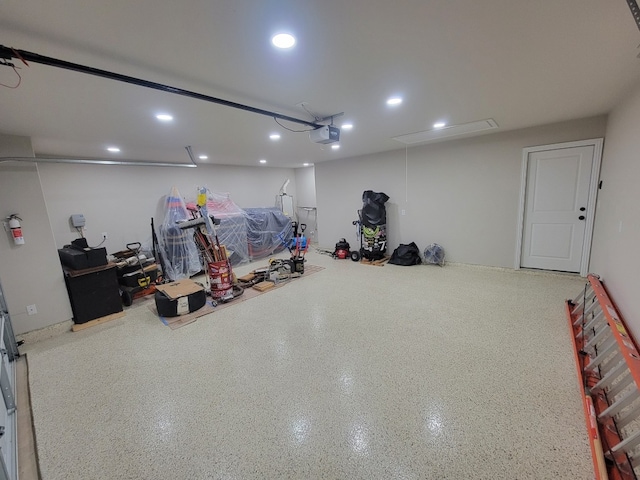 116 Shagbark Dr, Bastrop, TX 78602 - garage featuring a garage door opener and recessed lighting