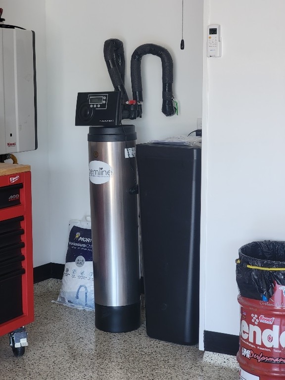 116 Shagbark Dr, Bastrop, TX 78602 - detailed view of speckled floor and a water softener system