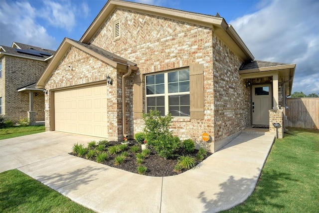 116 Shagbark Dr, Bastrop, TX 78602 - view of front of home featuring a garage, brick siding, and concrete driveway