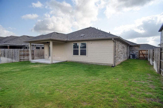116 Shagbark Dr, Bastrop, TX 78602 - back of house featuring a patio area, roof with shingles, and central AC unit