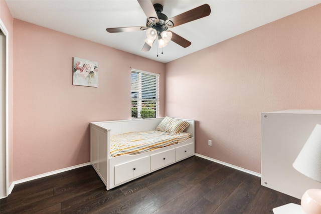 bedroom with ceiling fan and dark wood-type flooring