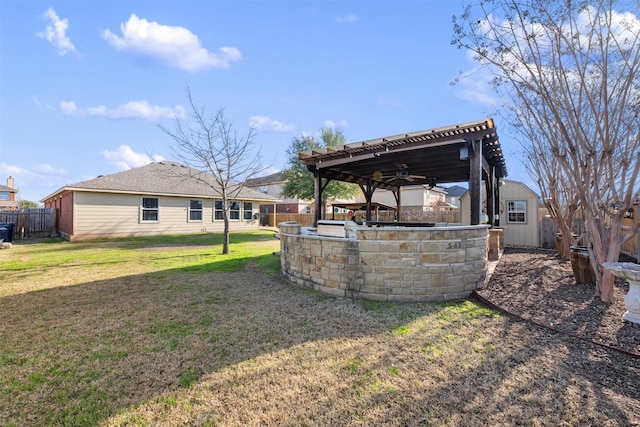 view of yard with ceiling fan and exterior kitchen