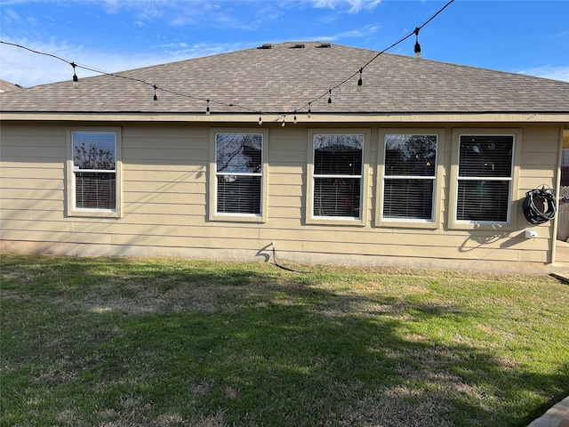 rear view of house featuring a lawn