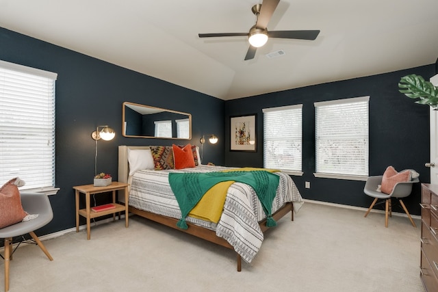 bedroom featuring light carpet, vaulted ceiling, and ceiling fan