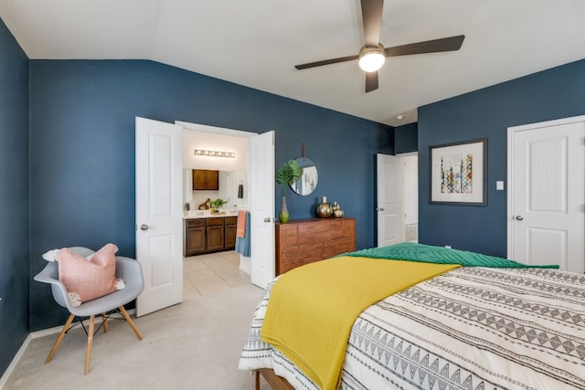 bedroom with ceiling fan, lofted ceiling, connected bathroom, and light colored carpet