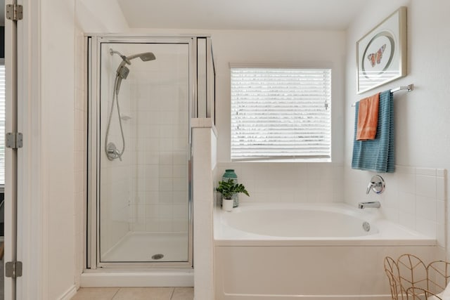 bathroom featuring plus walk in shower and tile patterned flooring