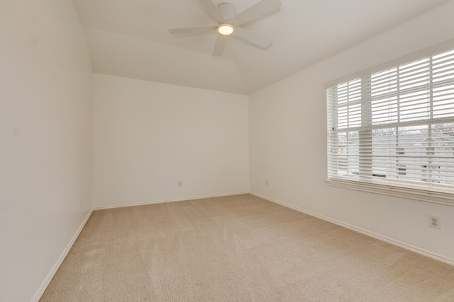 unfurnished room with vaulted ceiling, light colored carpet, and ceiling fan