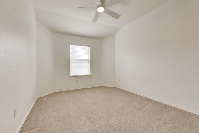 empty room with light carpet, lofted ceiling, and ceiling fan