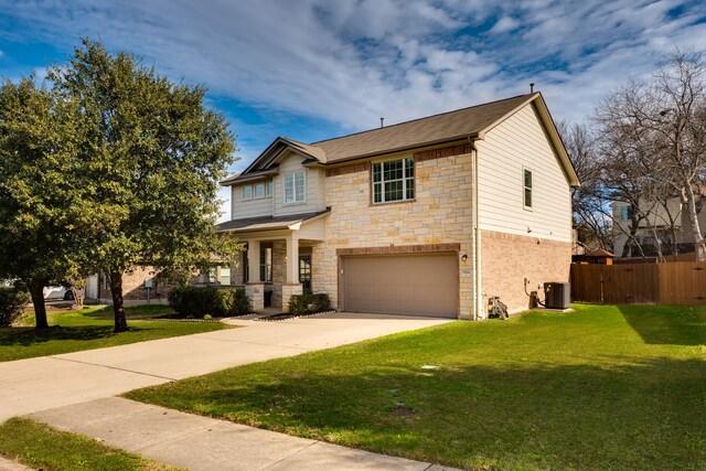 view of front of home featuring a garage, a front lawn, and central AC unit