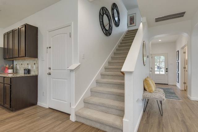 stairs with hardwood / wood-style flooring