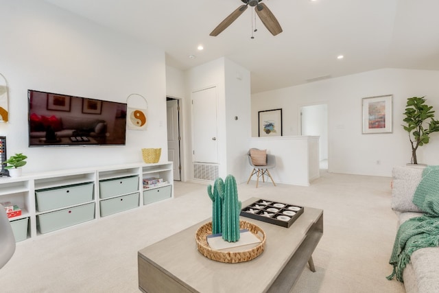 living room featuring ceiling fan, light colored carpet, and vaulted ceiling