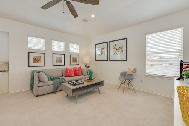 carpeted living room featuring ceiling fan