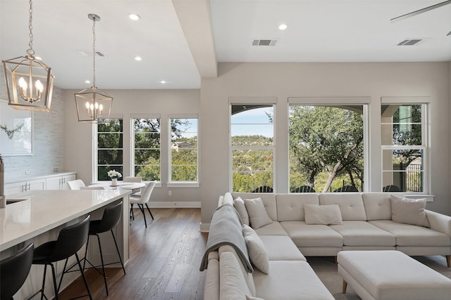 living room with a chandelier and hardwood / wood-style flooring