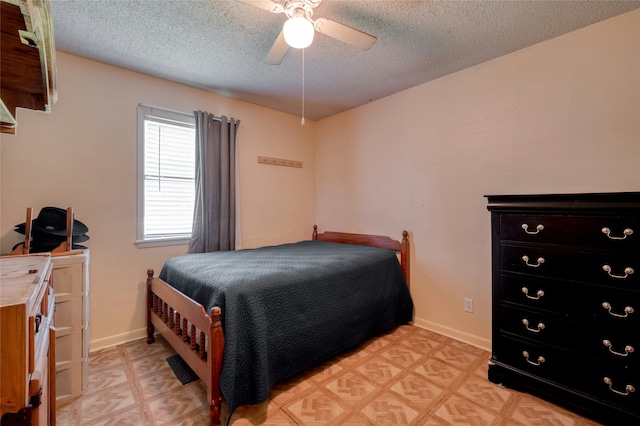 bedroom featuring a textured ceiling and ceiling fan