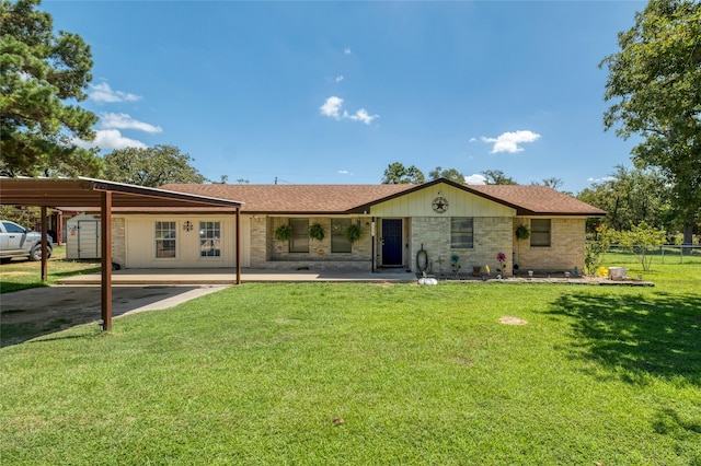 ranch-style house featuring a front lawn and a carport