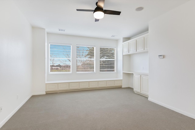 spare room with light carpet and ceiling fan