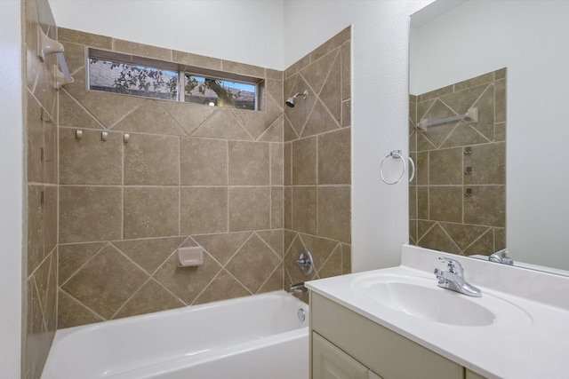 bathroom with tiled shower / bath combo and vanity