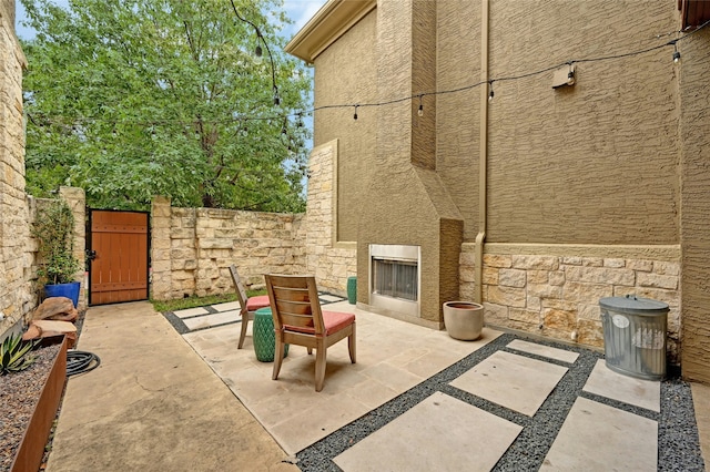 view of patio / terrace with exterior fireplace