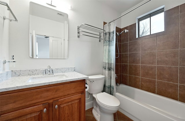 full bathroom with shower / bath combo with shower curtain, tile patterned floors, toilet, and vanity