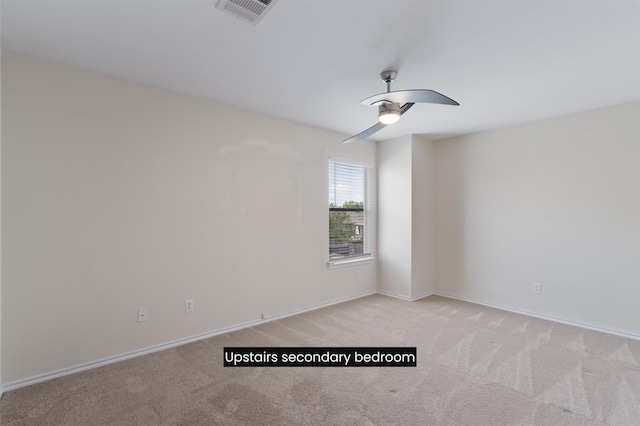 empty room with ceiling fan and light colored carpet